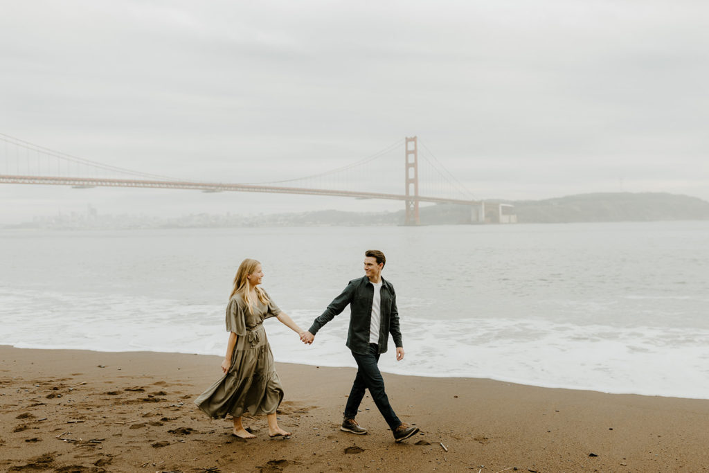 Rachel Christopherson Photography - Engaged couple holding hands in front of golden gate bridge, san francisco engagement photos