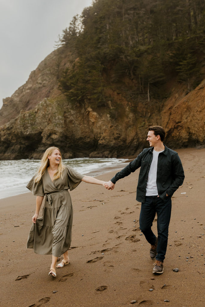 Rachel Christopherson Photography - Engaged couple holding hands on northern california beach , kirby cove engagement photos