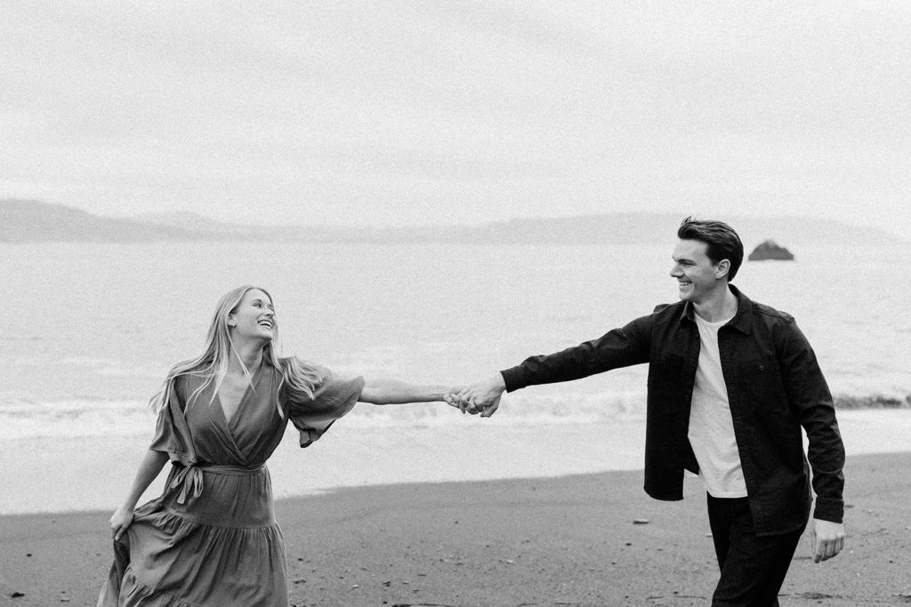 Rachel Christopherson Photography - Engaged couple holding hands on northern california beach , SF engagement photos, beach engagement photos