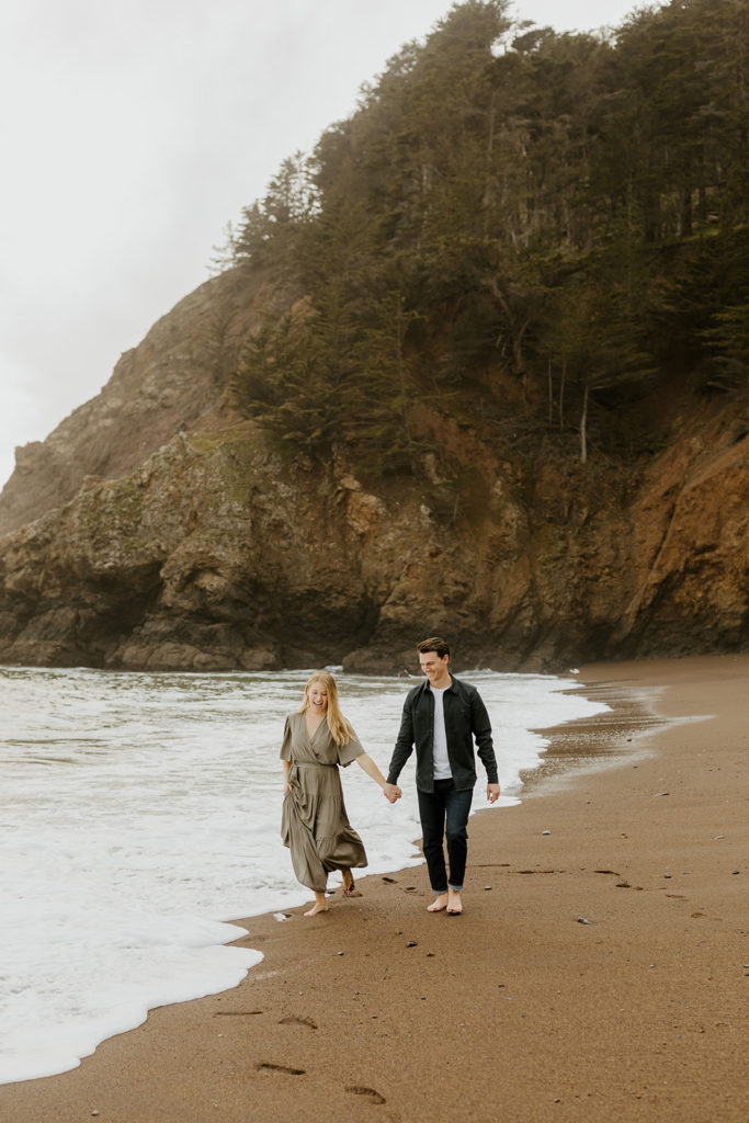 Rachel Christopherson Photography - Engaged couple holding hands on northern california beach , kirby cove engagement photos, beach engagement photos