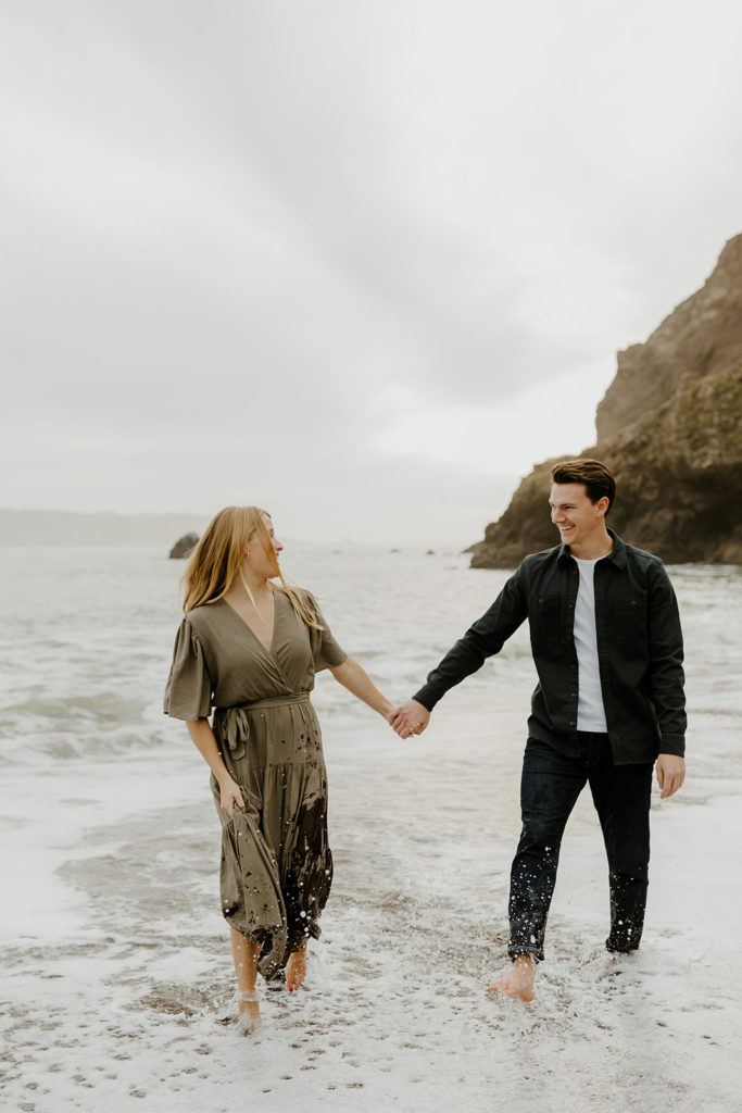 Rachel Christopherson Photography - Engaged couple holding hands on northern california beach , kirby cove engagement photos, beach engagement photos