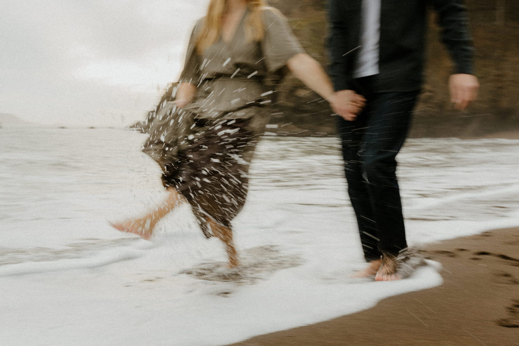 Rachel Christopherson Photography - Engaged couple playing in water and holding hands on northern california beach , Sacramento engagement photos, beach engagement photos