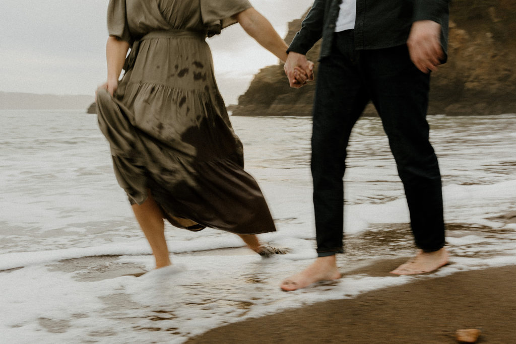 Rachel Christopherson Photography - Engaged couple playing in water and holding hands on northern california beach , kirby cove engagement photos, beach engagement photos