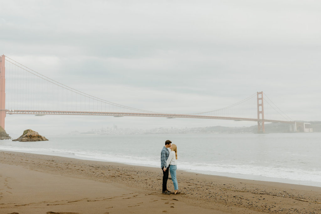 Rachel Christopherson Photography - Engaged couple kissing in front of golden gate bridge, bay area engagement photos, beach engagement photos