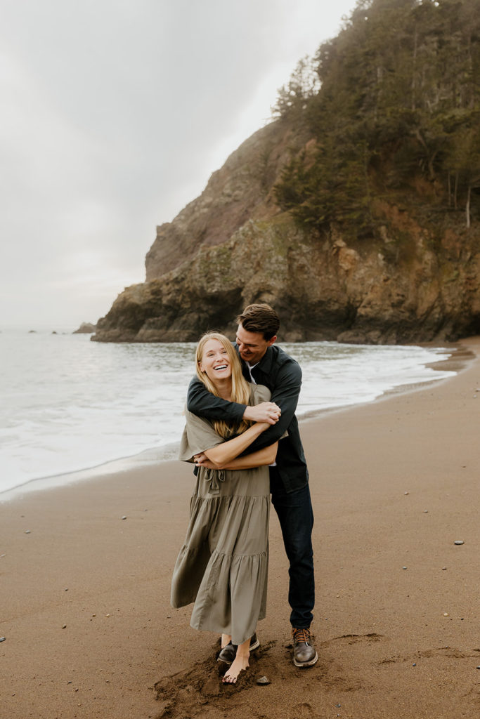 Rachel Christopherson Photography - Engaged couple holding each other on northern california beach , kirby cove engagement photos