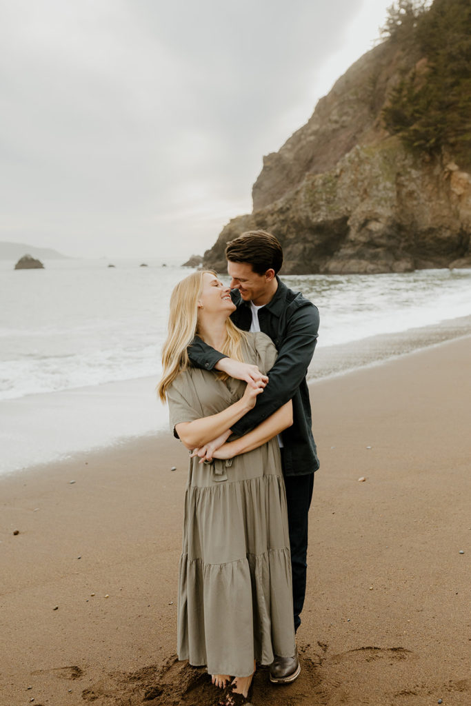 Rachel Christopherson Photography - Engaged couple holding each other on northern california beach , kirby cove engagement photos, beach engagement