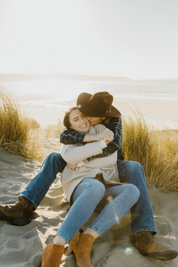 Rachel Christopherson Engagement Photographer-Engaged couple cuddling on beach-San Francisco Engagement Photos, Northern California Engagement Photos, Point Reyes Engagement Photos, Bodega Bay Engagement Photos, Dillon Beach Engagement Photos, Bay Area Engagement Photos