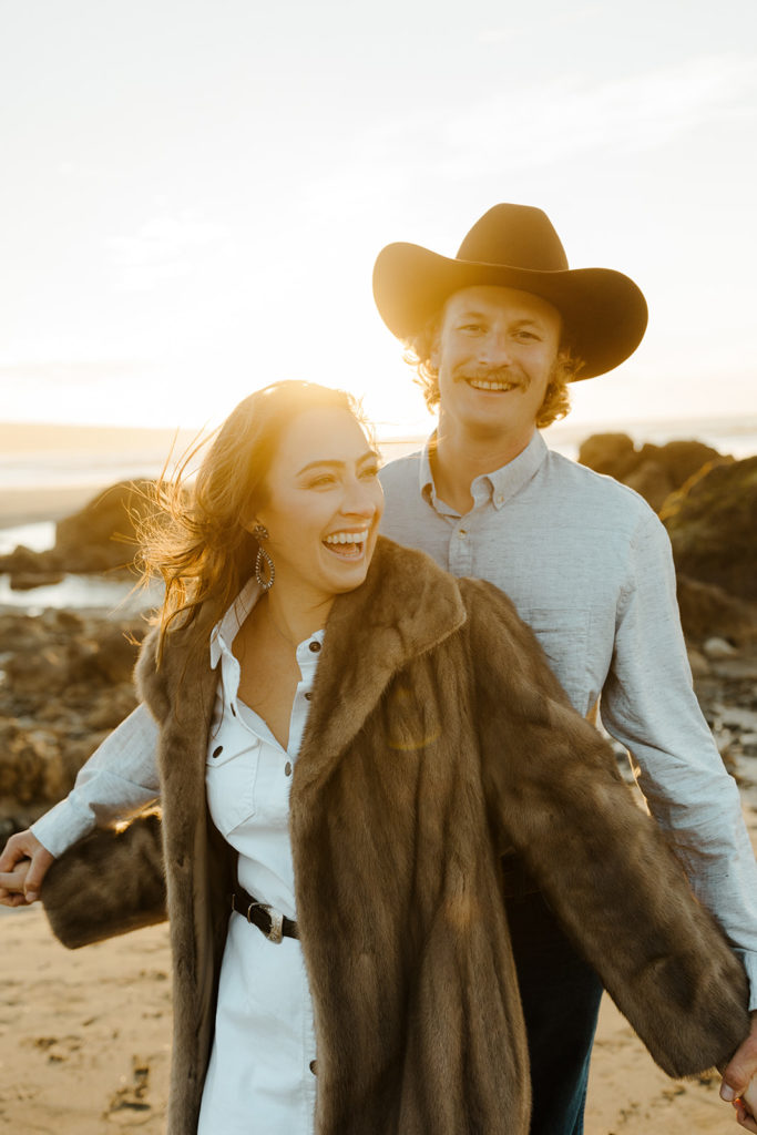 Rachel Christopherson Engagement Photographer-Engaged couple holding hands and laughing on beach-San Francisco Engagement Photos, Northern California Engagement Photos, Point Reyes Engagement Photos, Bodega Bay Engagement Photos, Dillon Beach Engagement Photos, Bay Area Engagement Photos