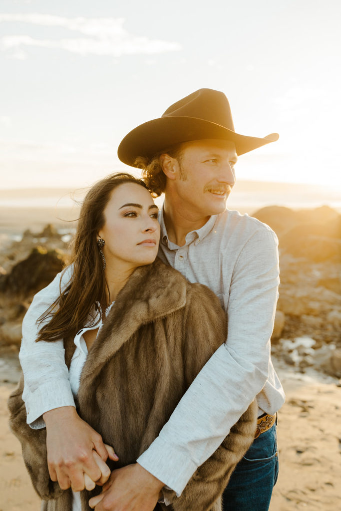 Rachel Christopherson Engagement Photographer-Engaged couple holding each other and looking off camera-San Francisco Engagement Photos, Northern California Engagement Photos, Point Reyes Engagement Photos, Bodega Bay Engagement Photos, Dillon Beach Engagement Photos, Bay Area Engagement Photos