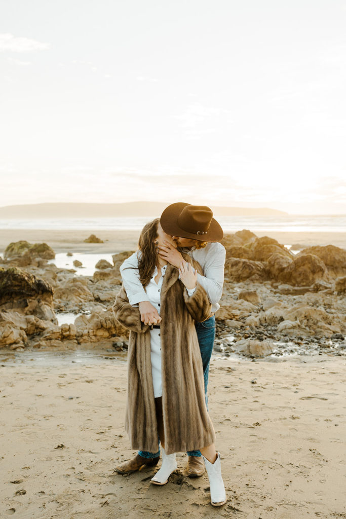 Rachel Christopherson Engagement Photographer-Engaged couple holding each other and kissing on beach-San Francisco Engagement Photos, Northern California Engagement Photos, Point Reyes Engagement Photos, Bodega Bay Engagement Photos, Dillon Beach Engagement Photos, Bay Area Engagement Photos