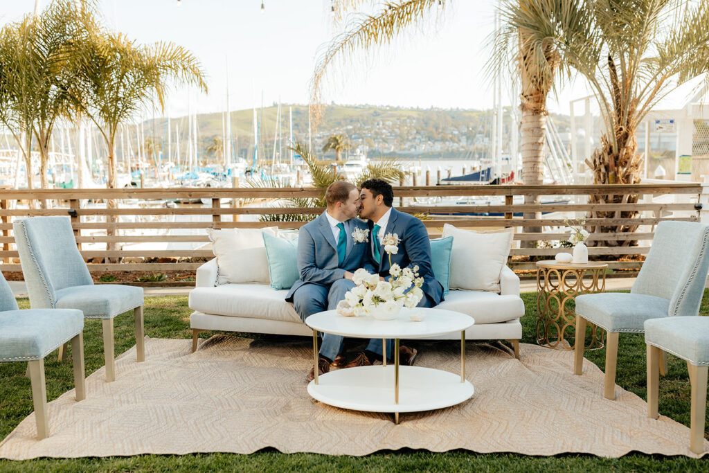 Rachel C Photography - bay area wedding venue, coastal wedding decor, grooms kissing in front of glen cove marina
