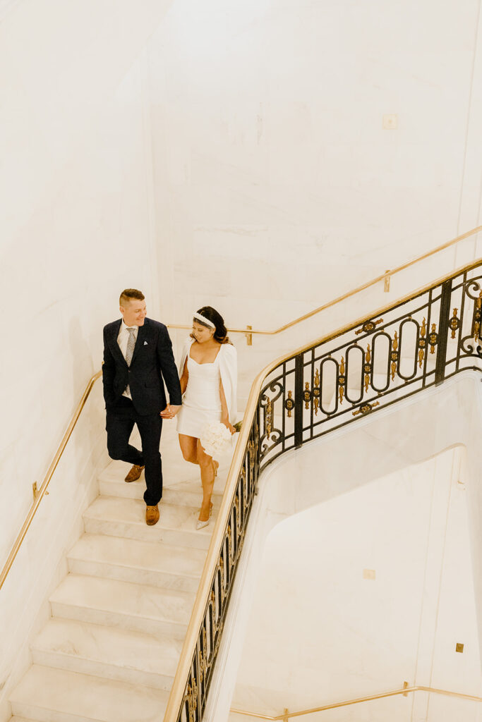 Rachel C Photography - Bride and groom walking down SF city hall stairs