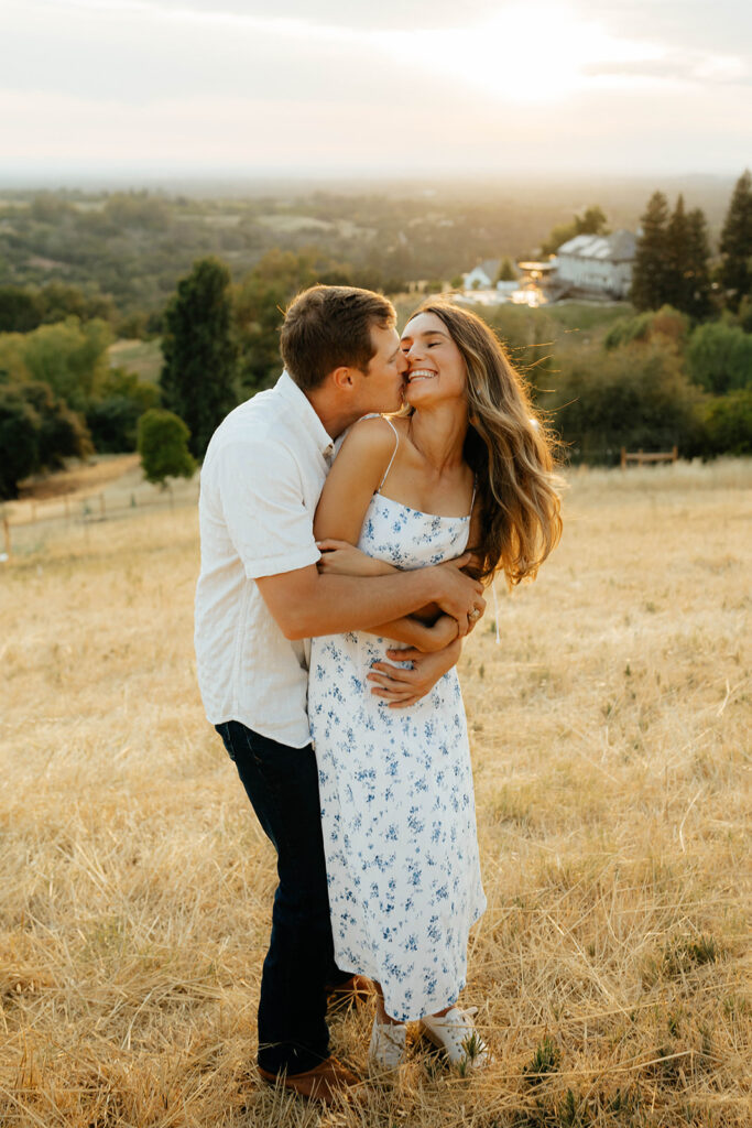 Couple posing for romantic field engagement photos in Auburn, California