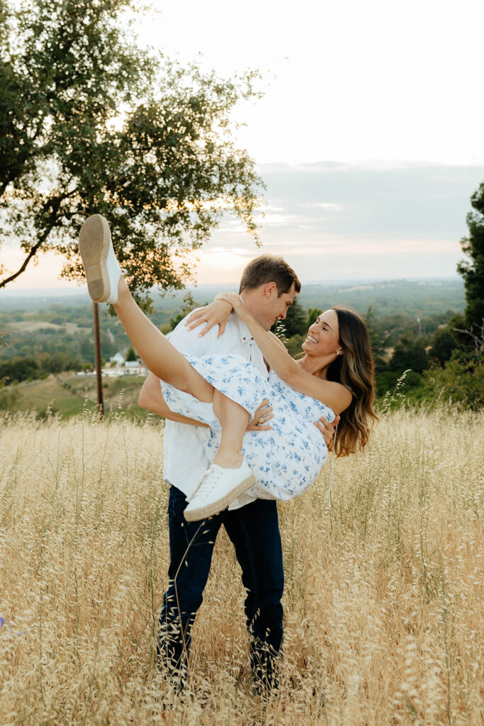 Couple posing for romantic field engagement photos in Auburn, California