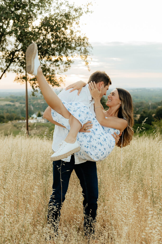 Couple posing for romantic field engagement photos in Auburn, California