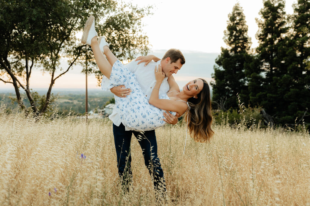 Couple posing for romantic field engagement photos in Auburn, California