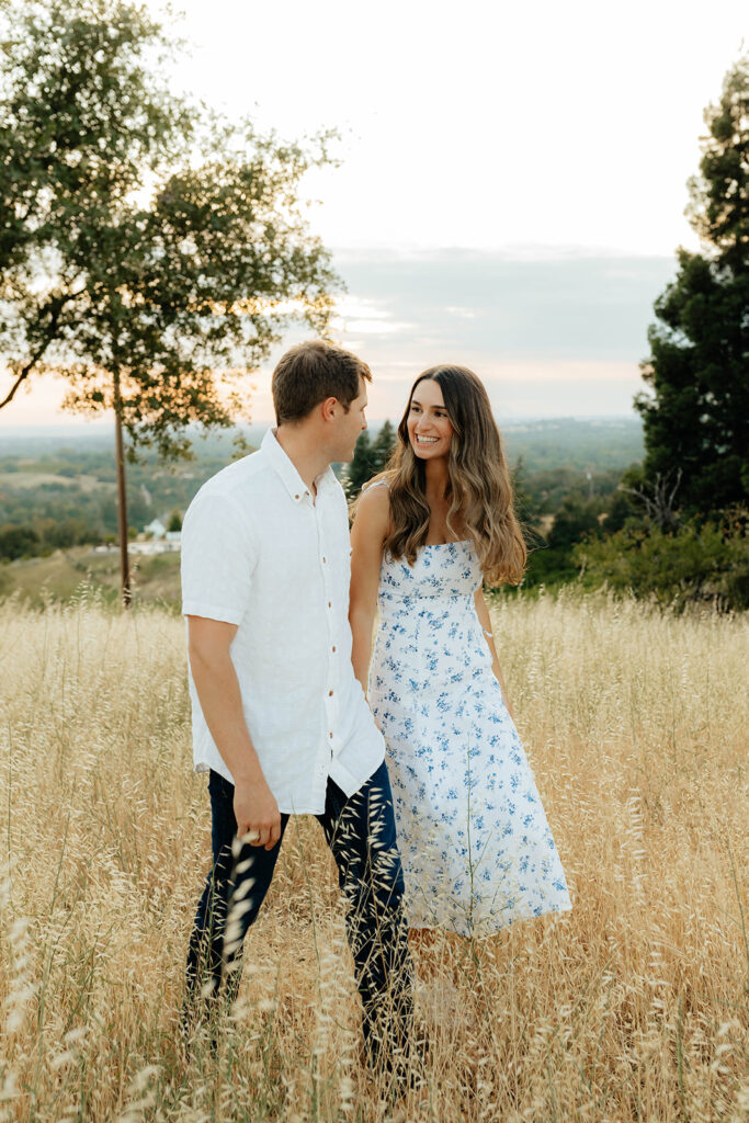 Couple posing for romantic field engagement photos in Auburn, California