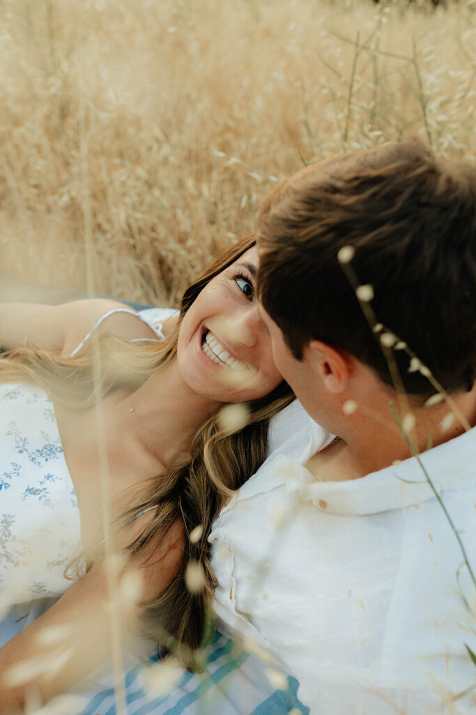 Couple posing for romantic field engagement photos in Auburn, California