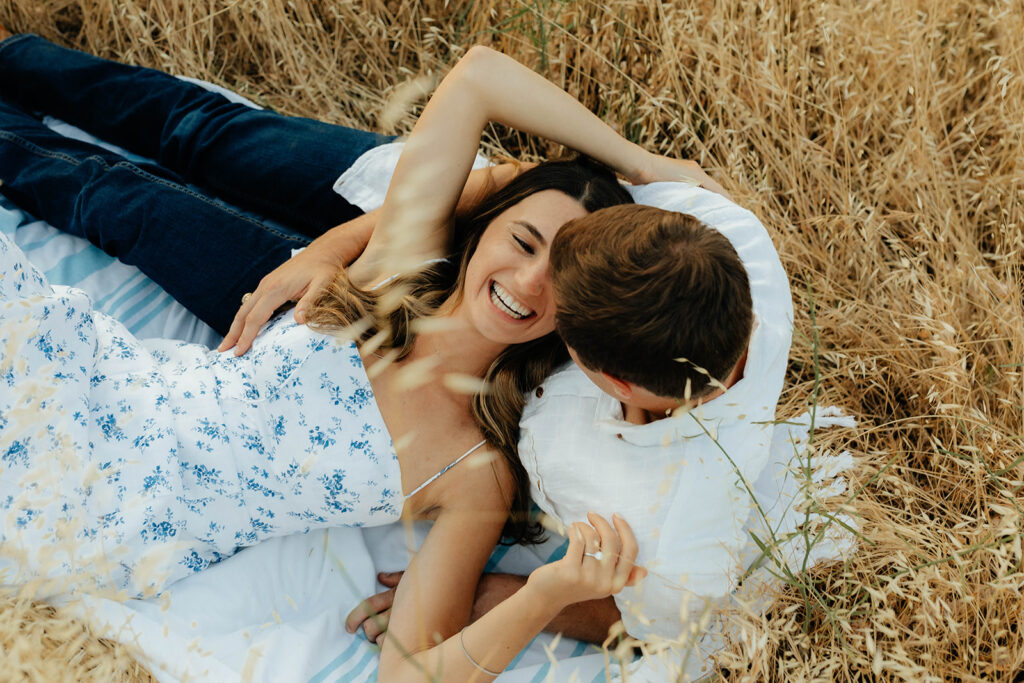 Couple posing for romantic field engagement photos in Auburn, California