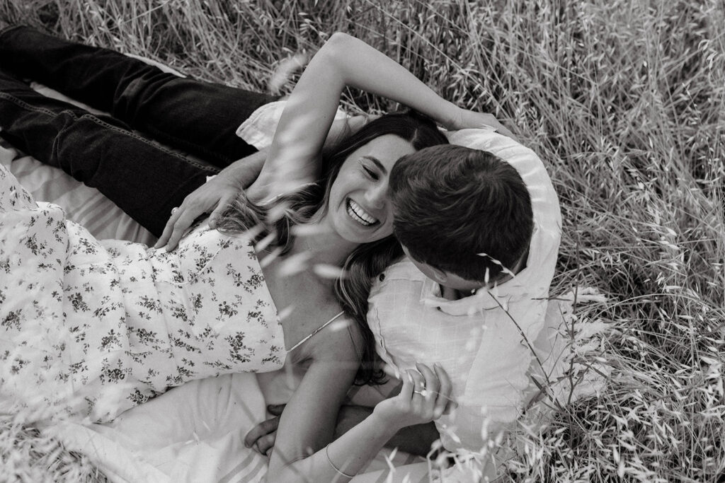 Couple posing for romantic field engagement photos in Auburn, California