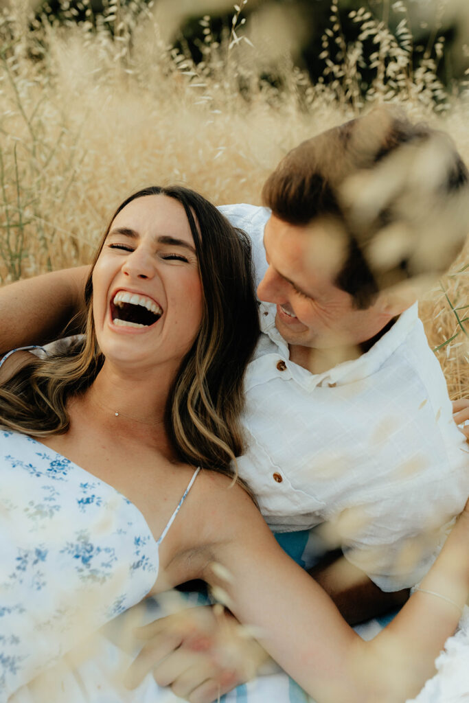 Couple posing for romantic field engagement photos in Auburn, California