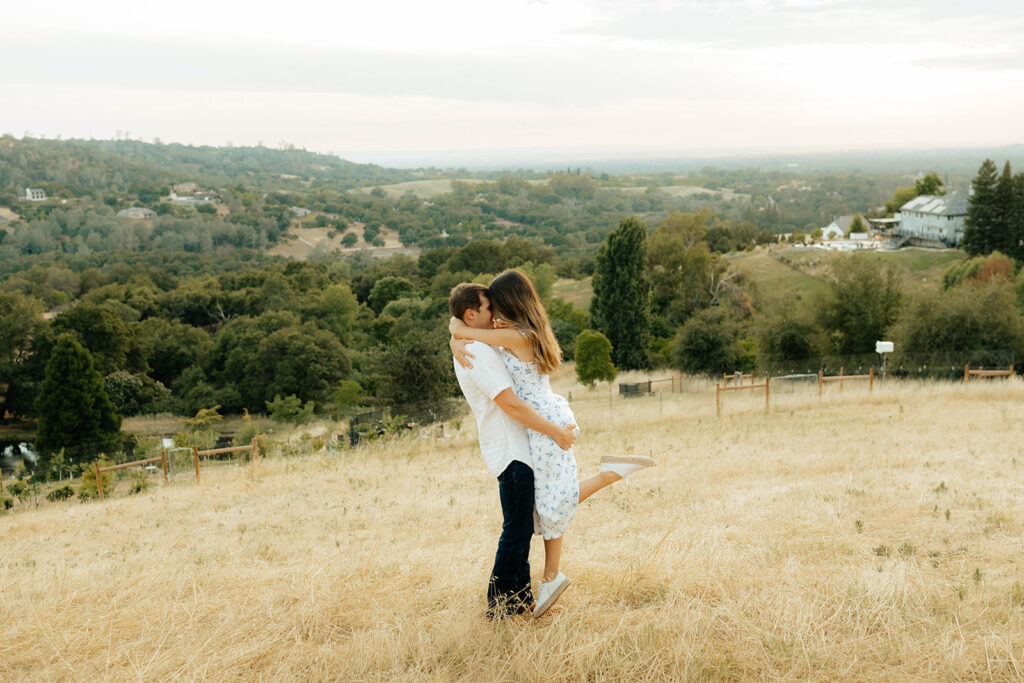 Couple posing for romantic field engagement photos in Auburn, California