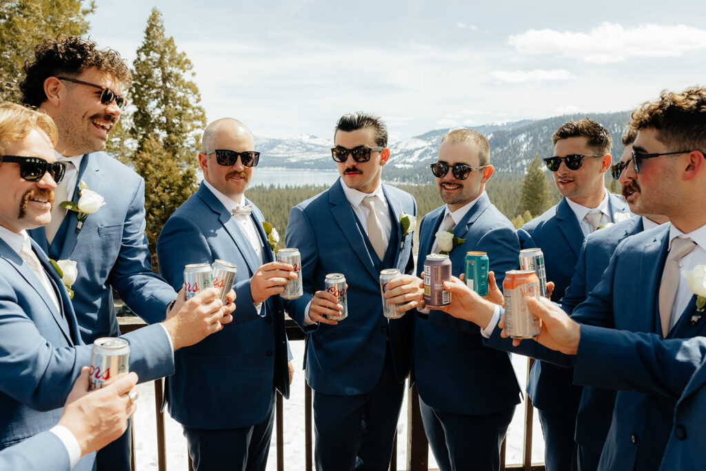 Groom and groomsmen toasting their beers