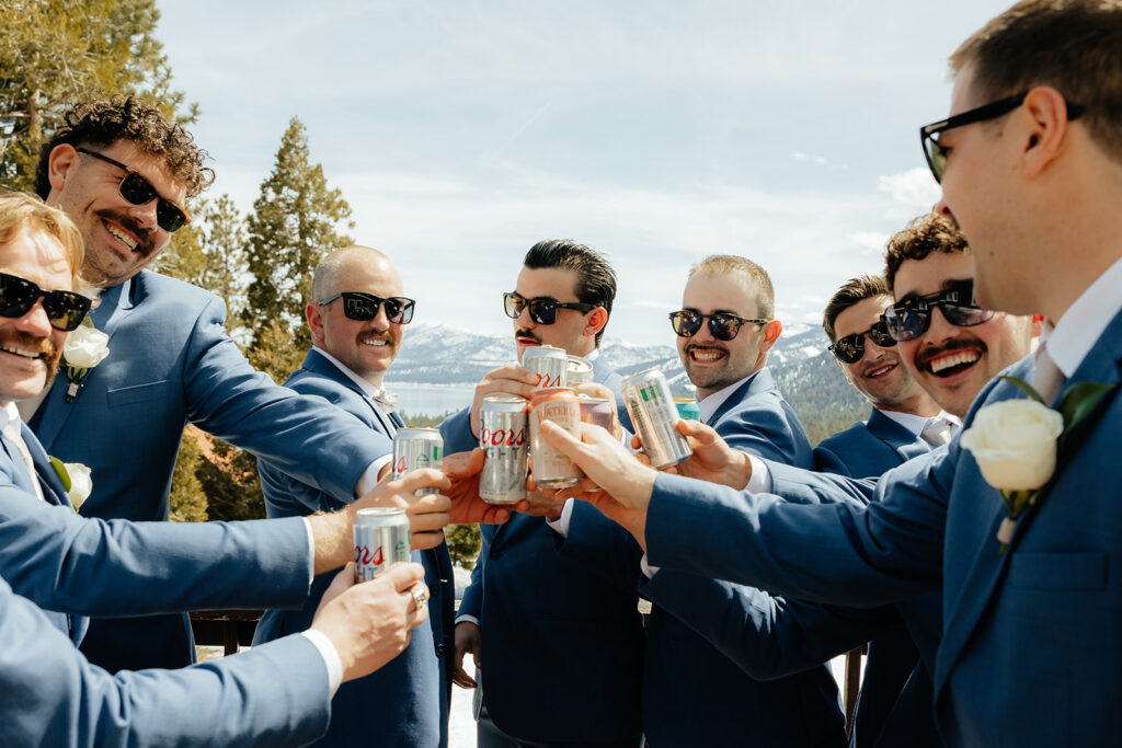 Groom and groomsmen toasting their beers