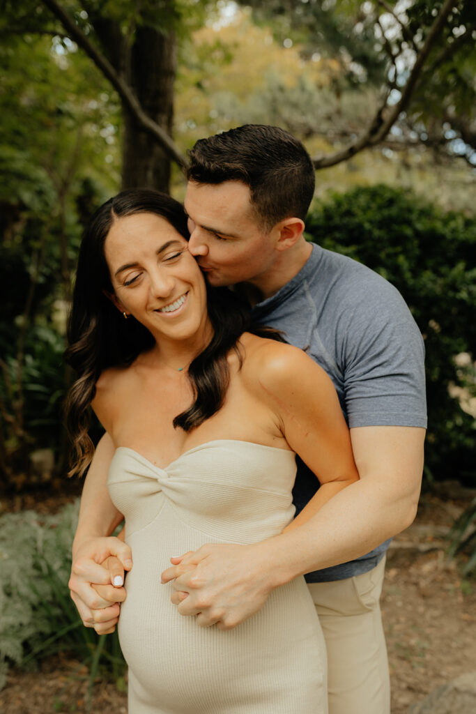 Man kissing pregnant woman during photoshoot