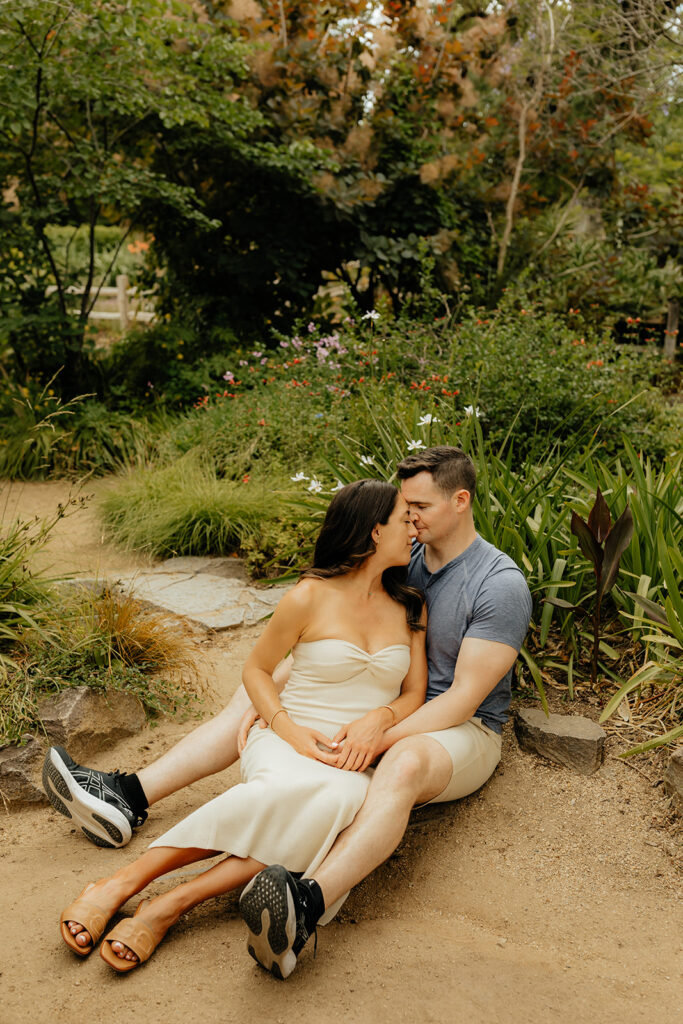 Couple sitting on the ground during photoshoot