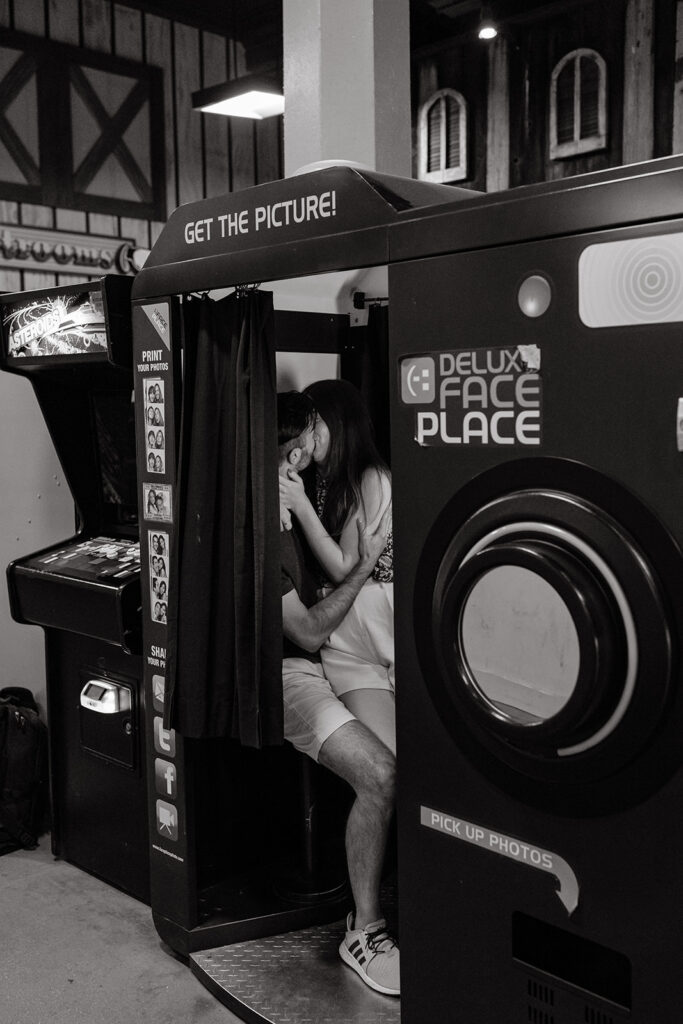 Couple posing for photos in photobooth