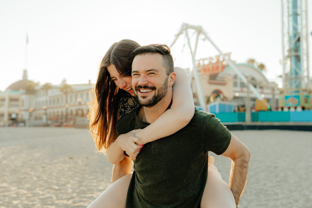 Couples playful engagement photos on Santa Cruz beach