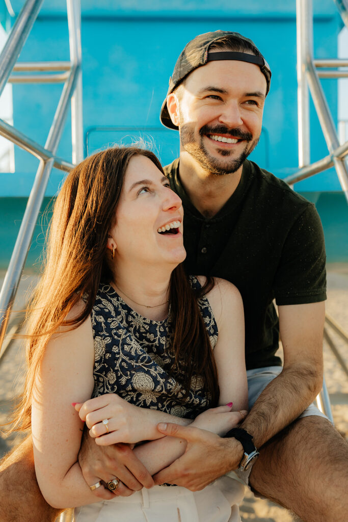 Couple posing on Santa Cruz beach for engagement session