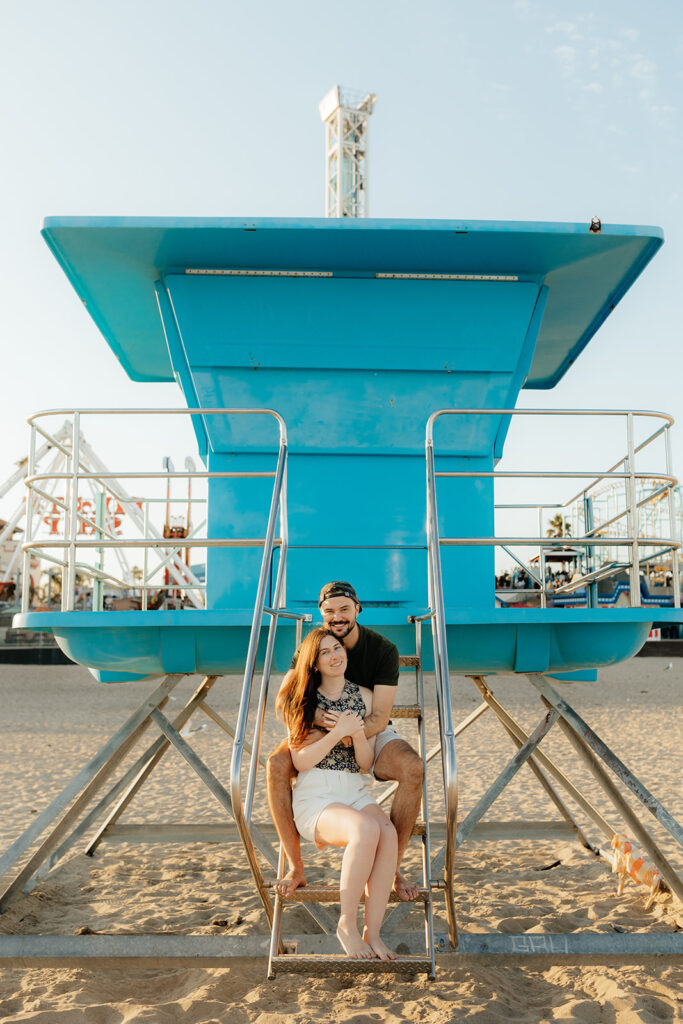 Couple posing on Santa Cruz beach for engagement session