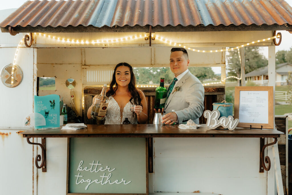 Bride and groom at their mobile wedding bar