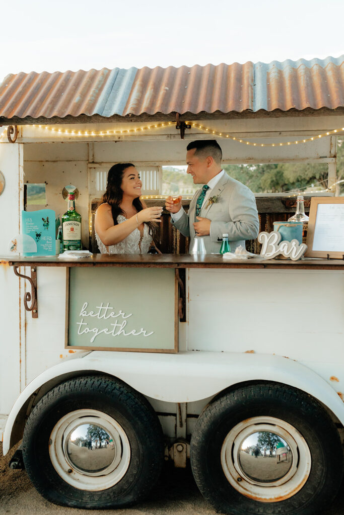 Bride and groom at their mobile wedding bar