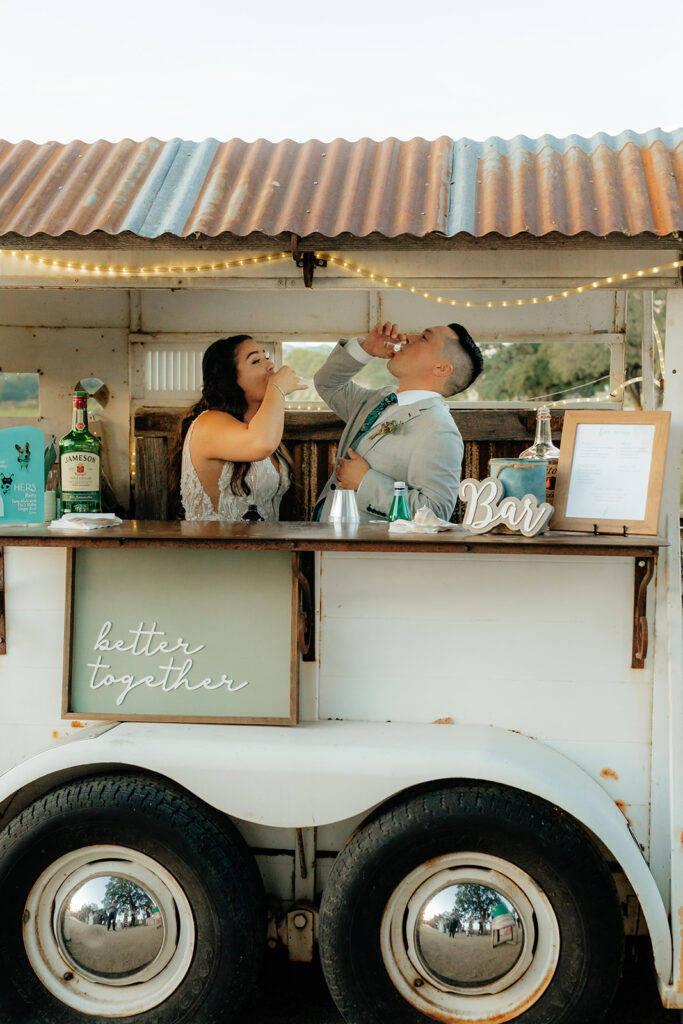 Bride and groom at their mobile wedding bar