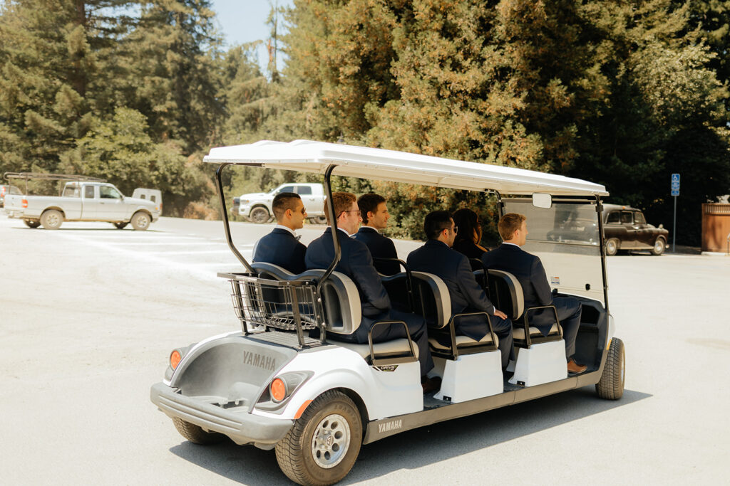Groom and groomsmen riding in golf cart