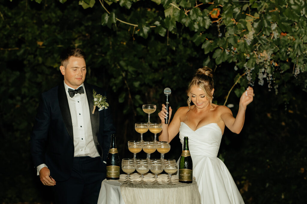 Bride and groom doing champagne tower