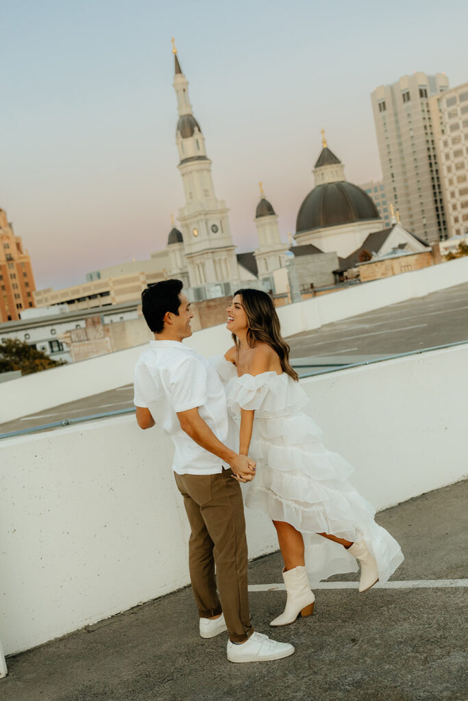 Playful couples rooftop downtown engagement photos in Sacramento