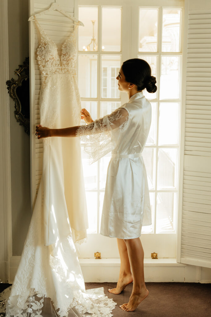 Bride admiring wedding dress