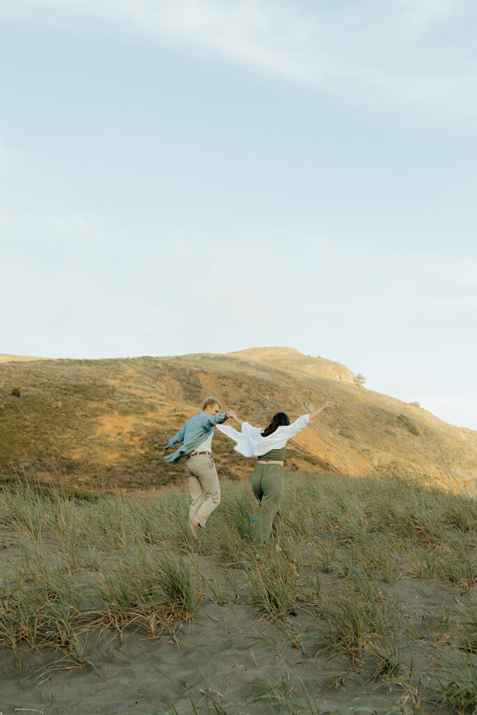 Couple running in an open field