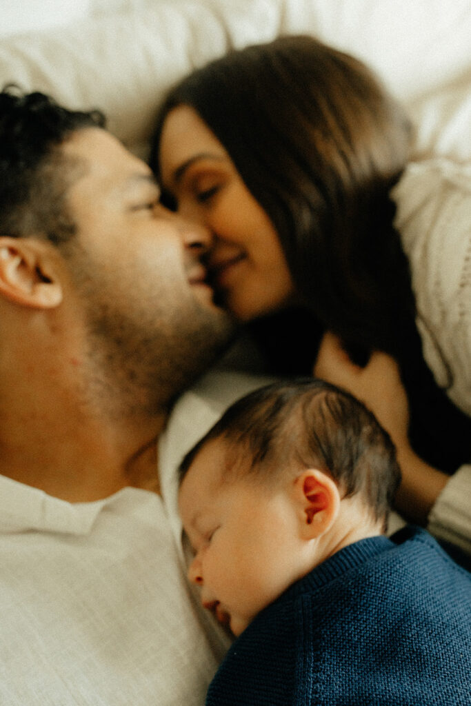 Mother, father, and baby boy during sweet at home newborn photography session in LA