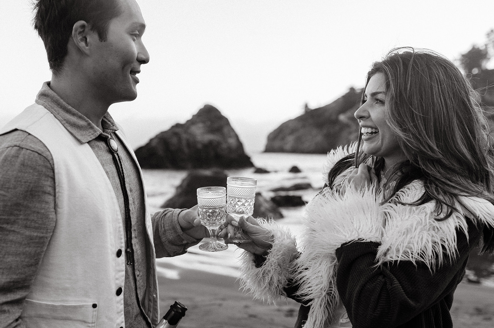 Bride and groom drinking champagne on Muir Beach 