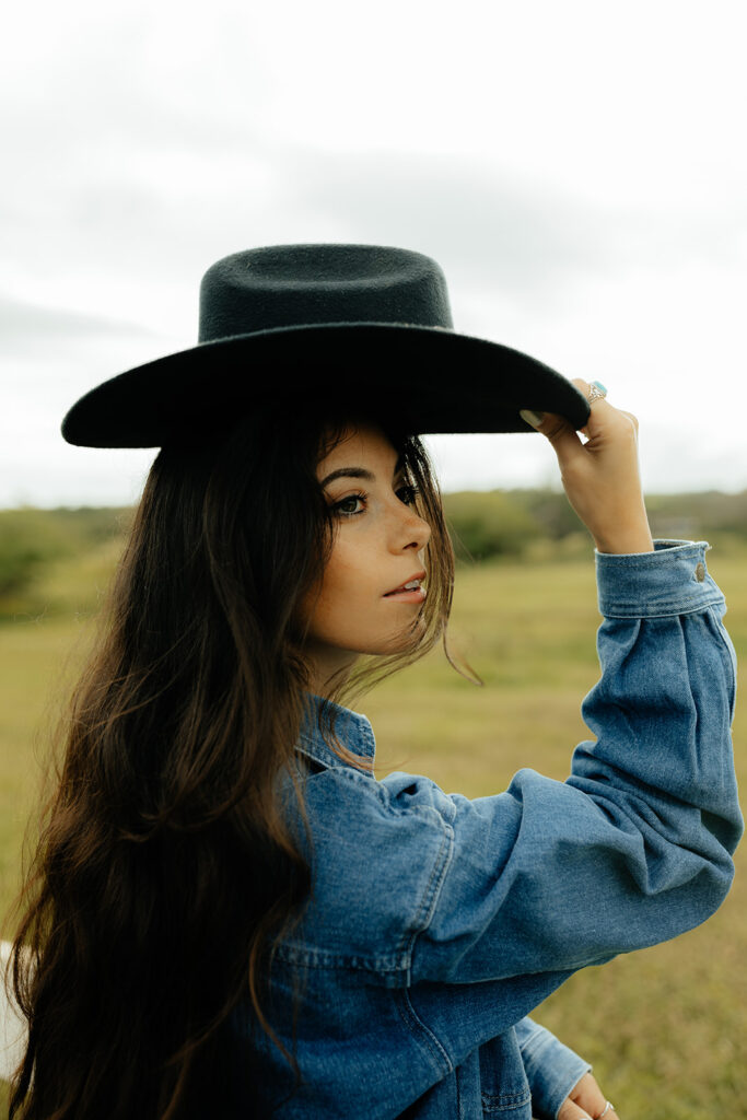 girl wearing a cowboy hat during her photoshoot