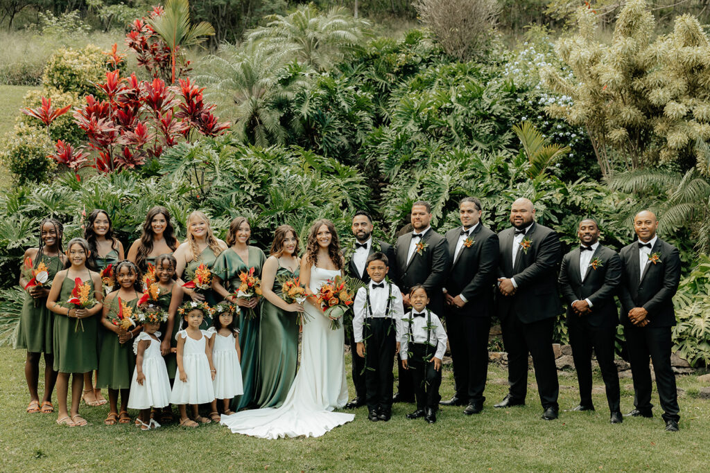 bride and groom with their friends at their Colorful Eco-Friendly Wedding at Kualoa Ranch, HI