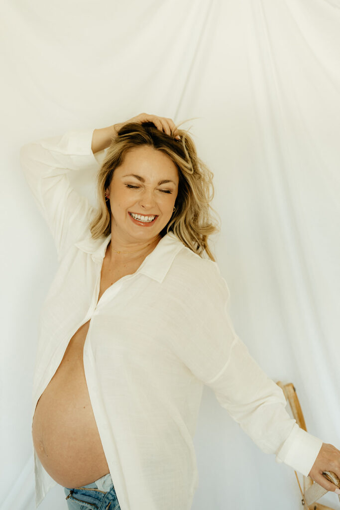 mom to be laughing during her maternity photoshoot