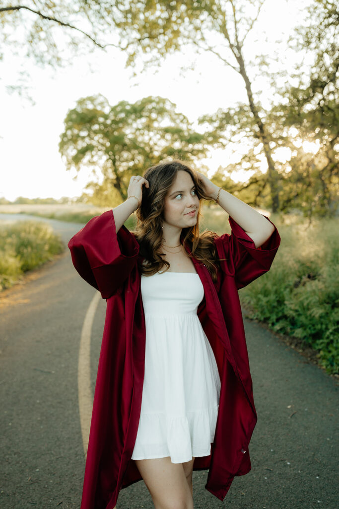 grad photoshoot with a red robe 