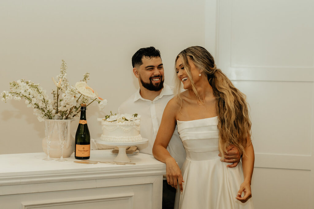 bride and groom before cutting their wedding cake