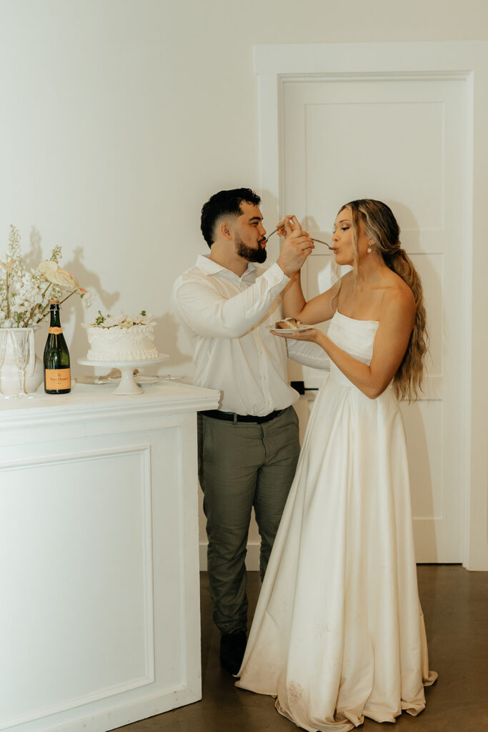 bride and groom trying their wedding cake at their ethereal intimate wedding